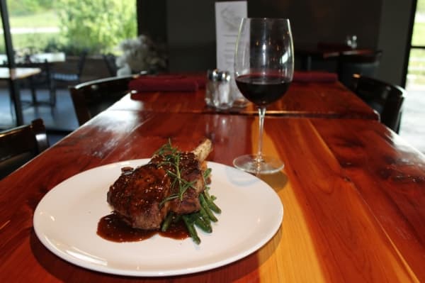 The pork chop comes glazed in a maple syrup and mustard sauce. ($28) (Eva Vigh/Community Impact Newspaper)