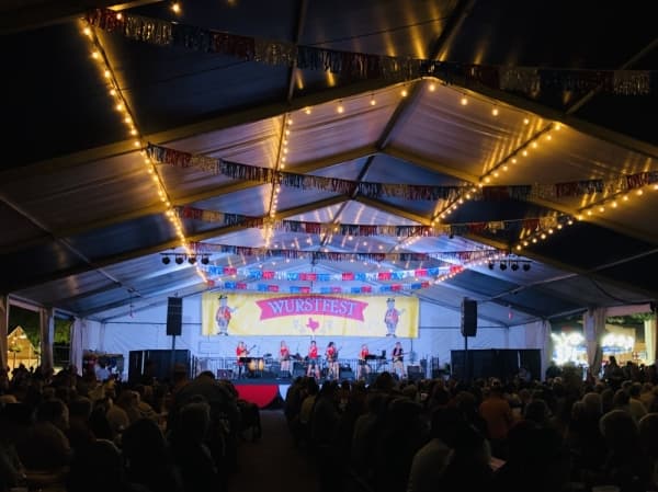 Die Bayrischen Hiatamadln, a six-person, all-female band from the Greater Munich area, performs on Day 4 of Wurstfest. (Ian Pribanic/Community Impact Newspaper)