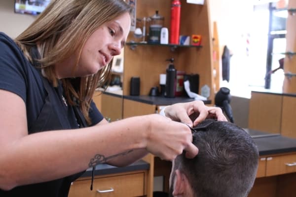 Shirley takes time to make an even cut. (Lindsey Juarez Monsivais/Community Impact Newspaper)