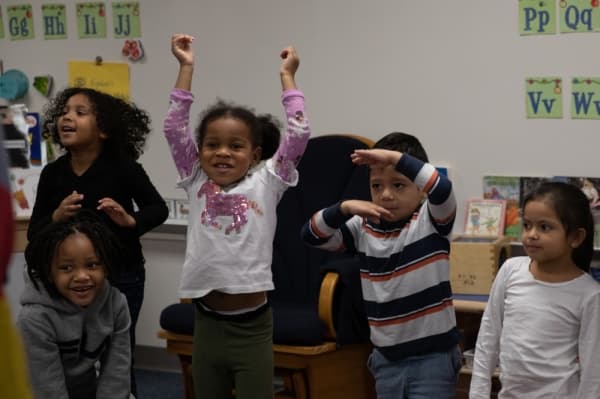 Students from Kristi Vest's Head Start class celebrate their teacher's grant award for pre-K writing. (Liesbeth Powers/Community Impact Newspaper)