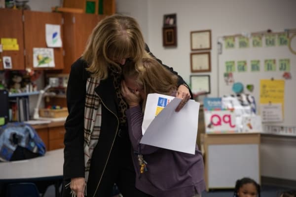 Head Start teacher Kristi Vest recieves a grant for improvements to the writing program at the pre-K level, including tools to strengthen motor skills and writing strokes. Superintendent Sara Bonser embraces Vest as she presents the award.
