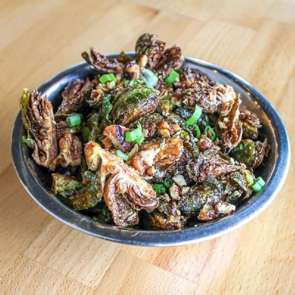 Crispy Brussels Sprouts: The popular dish is made with Dijon rum glaze, toasted pecans and chives. (Courtesy Industry)