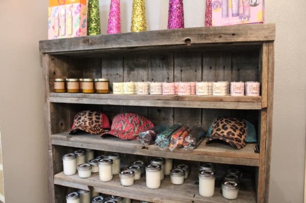 The boutique offers candles, hats and more. (Marisa Charpentier/Community Impact Newspaper)