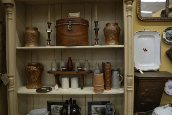 Antique items range from candle holders to ceramics.
