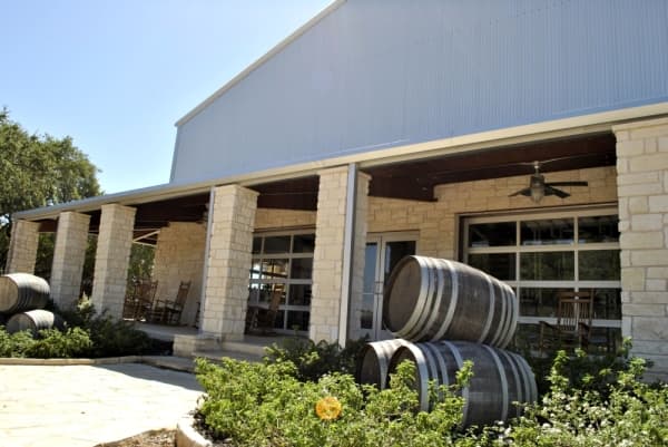 In addition to indoor seating, 5 Stones Artisan Brewery has a wrap-around porch and outdoor tables under shady trees. (Chelsea Bagley/Community Impact Newspaper)