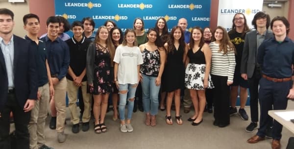 Some of Leander ISD’s 46 National Hispanic Scholars are pictured with LISD trustees during the Nov. 21 board meeting. (Brian Perdue/Community Impact Newspaper)