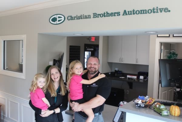 Crystal and Brad Escue hold their two daughters, Madeline (left) and Hannah, at their business, Christian Brothers Automotive in Leander, which recently celebrated its one-year anniversary.
BRIAN PERDUE/COMMUNITY IMPACT NEWSPAPER