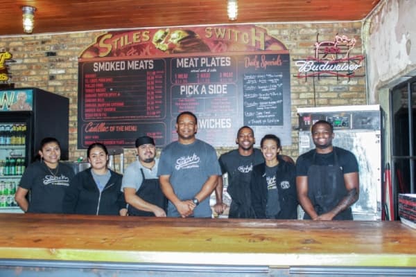 Stiles Switch General Manager Duane Jackson, center, stands behind the counter with his staff. He grew up in Tyler, Texas, along with owner Shane Stiles. Emma Freer/Community Impact Newspaper