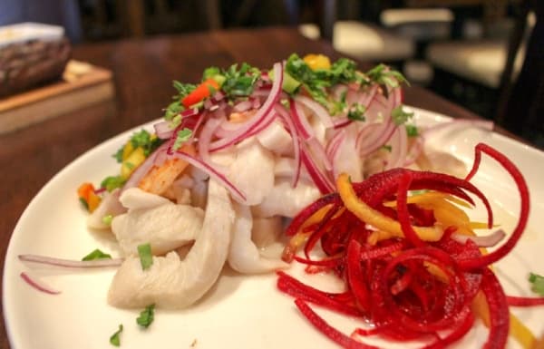 Ceviche peruano ($14) is an appetizer made with shrimp and fish marinated in spicy lemon with purple onions, choclo and sweet potatoes. (Kara McIntyre/Community Impact Newspaper)