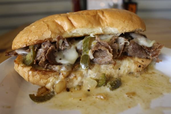 The Texas beef dip sandwich ($9) features sliced beef, grilled onions and jalapenos with melted Swiss cheese and a cup of Au Jus for dipping. (Kara McIntyre/Community Impact Newspaper)