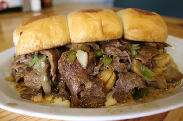 Philly sliders ($9) features philly cheesesteak, grilled onions and queso cheese are served on three sliders. (Kara McIntyre/Community Impact Newspaper)