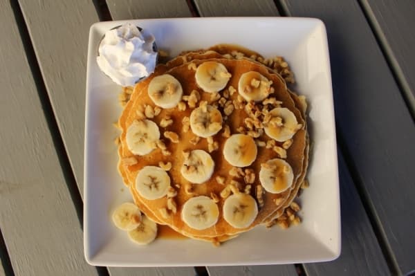 The caramel banana pancakes ($8.95) include two pancakes topped with fresh banana slices, walnuts and a caramel drizzle, served with whipped cream and a side of bacon, sausage or chicken sausage. 