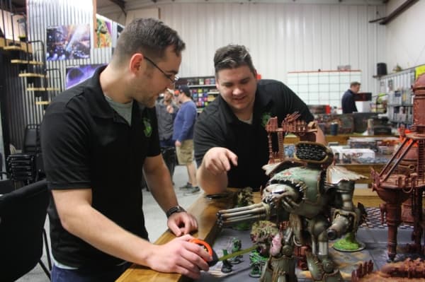 Johnathan Lindsley (right) and Ben Allred show off gaming accessories used in the tabletop game Warhammer 40K. (Shawn Arrajj/Community Impact Newspaper)