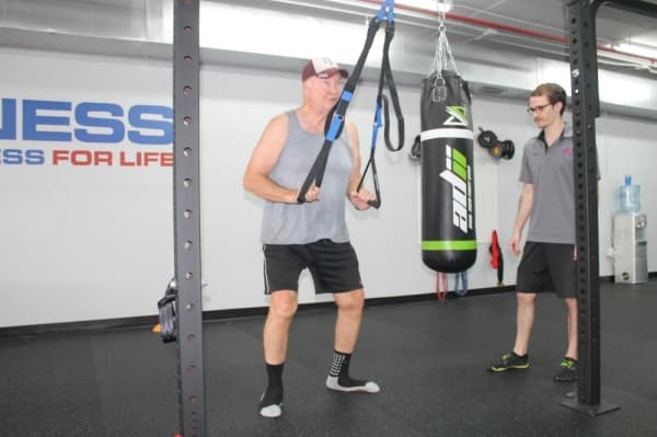 Bill Schneider can more easily play with his grandchildren after training for a few months at TriFitness Gym. (Jake Magee/Community Impact Newspaper)