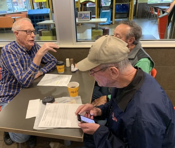 Lewis Reichert, Ted Wilson and Dick Baker plan for the day's projects in their makeshift office at McDonald's. Seniors Helping Seniors meets there every Wednesday morning to go over work orders and get assignments. (Jean Ann Collins/Community Impact Newspaper)