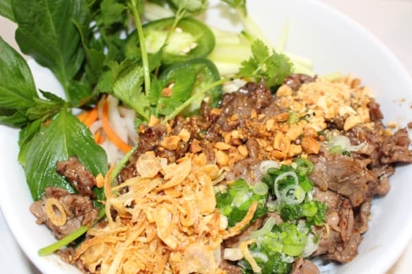 The lemongrass garlic beef vermicelli special ($11.99) is served in a bowl of noodles with lettuce, bean sprouts, cucumbers, carrots, peanuts and fish sauce. Ben Thompson/Community Impact Newspaper