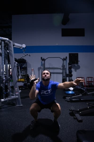 ProCore Fitness trainer Tony West does an example set of goblet presses. (Liesbeth Powers/Community Impact Newspaper)