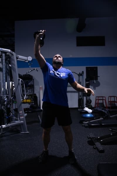 ProCore Fitness trainer Tony West does an example set of goblet presses. (Liesbeth Powers/Community Impact Newspaper)