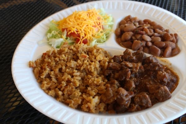 Beef Guisado Plate ($7.95): Angus beef cooked in its own juices with spices, Spanish rice, charro beans and a salad of lettuce, tomatoes and cheese. (Elizabeth Ucles/Community Impact Newspaper)