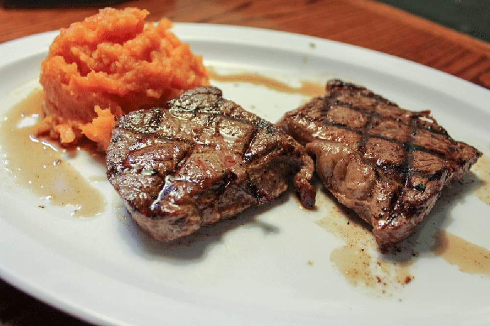 The sirloin steak ($12.90) is served alongside mashed sweet potatoes. (Hannah Zedaker/Community Impact Newspaper) 