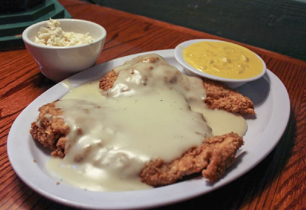 The chicken-fried chicken ($11.90) is smothered in gravy and a patron’s choice of two sides, such as mac ‘n’ cheese and coleslaw. (Hannah Zedaker/Community Impact Newspaper) 