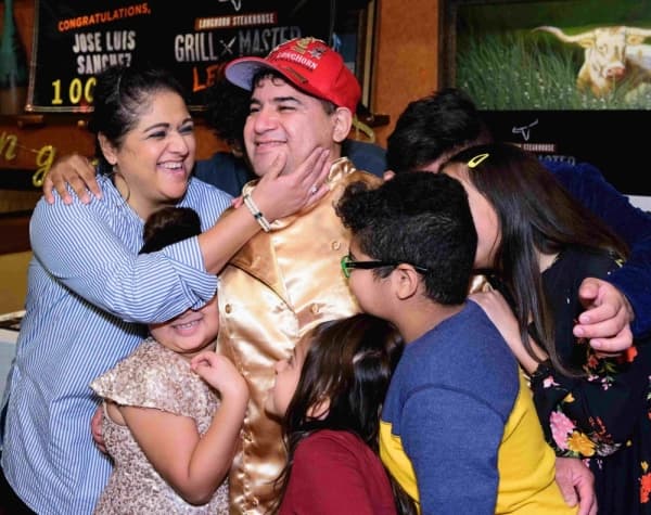 Cedar Park resident Jose Luis Sanchez celebrates with his family after receiving a $2,500 award from LongHorn Steakhouse in Cedar Park. (Courtesy LongHorn Steakhouse)