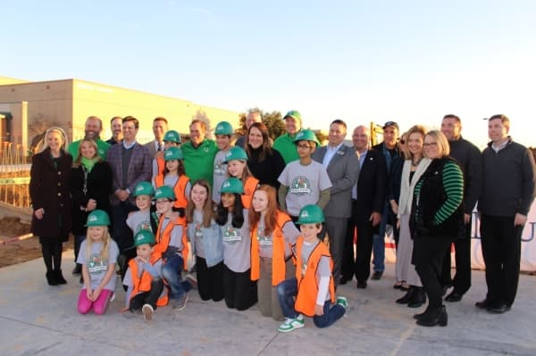 Carroll ISD Bond Builders, the board of trustees, city of Southlake and district staff take a photo at the Dec. 11 slab signing party. (Miranda Jaimes/Community Impact Newspaper)