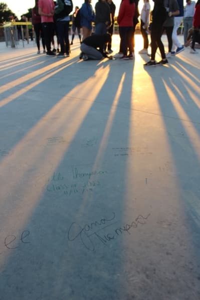 Carroll ISD students and supporters sign the slab of the upcoming new music center Dec. 11. (Miranda Jaimes/Community Impact Newspaper)