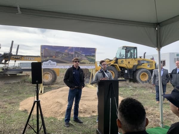 Owners Aaron and Taylor Holmes addressed attendees at the groundbreaking ceremony for Spare Birdie Public House Dec. 14. (Marisa Charpentier/Community Impact Newspaper)