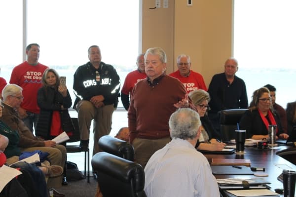 Owen Parker, president of Harris County Municipal Utility District 109 in Atascocita, faces Lake Conroe residents as he urges them to consider flooding downstream. Parker was booed by many in attendance. (Eva Vigh, Community Impact Newspaper)