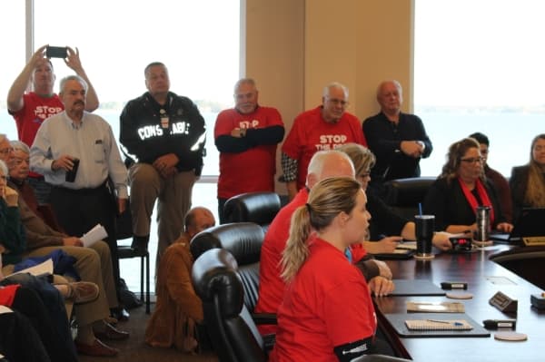 A Lake Conroe resident urges the board to stop the lake lowering. (Eva Vigh, Community Impact Newspaper)