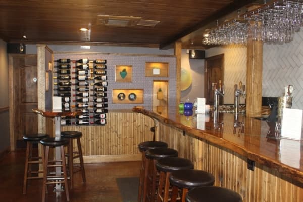 The interior of Patio Dolcetto is decorated with local art and bar tops made from a fallen pecan tree.