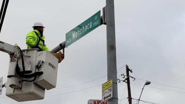 New street signs for Menchaca Road are officially installed within city limits