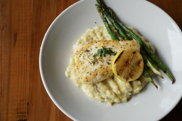 The halibut ($27) is served with mushroom risotto and asparagus. (Gavin Pugh/Community Impact Newspaper)