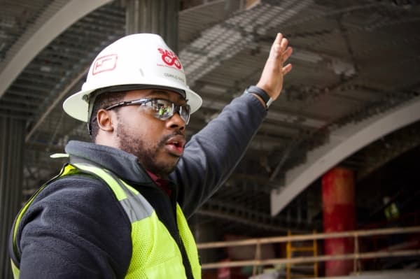 Oswald Nixon, a hotel project engineer with Hensel Phelps, points to the site of a future lobby bar. (Taylor Jackson Buchanan/Community Impact Newspaper)