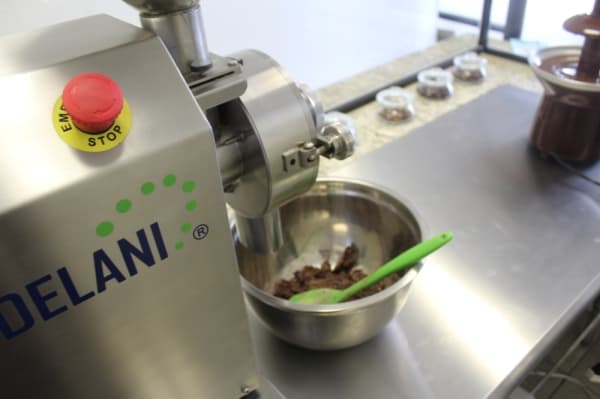 The chocolate-making machinery is on display for customers to see. (Marisa Charpentier/Community Impact Newspaper)