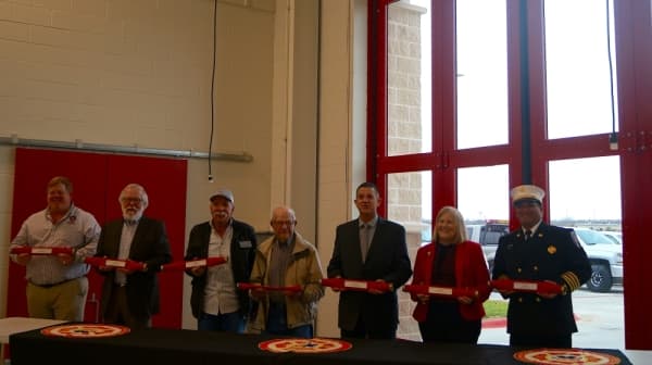 Vic Stern (center), a former Hutto firefighter, is the namesake behind the city's newest fire station. (Kelsey Thompson/Community Impact Newspaper)