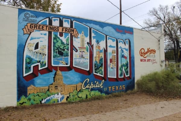The outside of Sanders’ studio features the popular “Greetings from Austin” mural. In the last few years, Sanders said, it has become much more popular, attracting tour buses and travelers alike. Emma Freer/Community Impact Newspaper