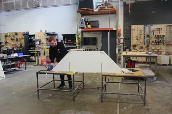 Accomplice designer Blake Manns works in the company's physical design space. (Olivia Aldridge/Community Impact Newspaper)