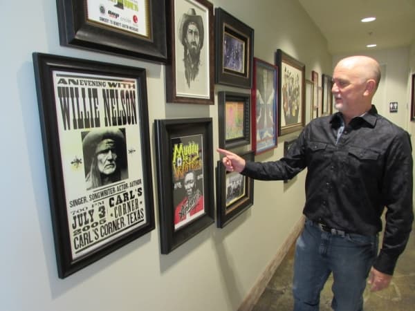 Owner Rick Wahlberg has a collection of concert posters displayed at Shore.  (Nicholas Cicale/Community Impact Newspaper)