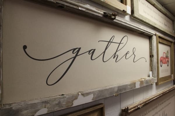 Lyszaz designs all of the canvas signs in-store, handpicking the quotes and images. (Kara McIntyre/Community Impact Newspaper)