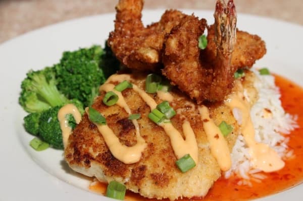 The island mahi ($20) sits on a bed of white rice and is served with sauteed broccoli and two large coconut-crusted shrimp. (Renee Yan/Community Impact Newspaper)