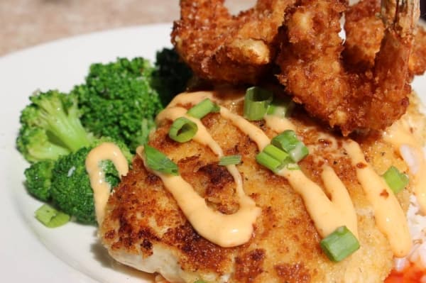 The island mahi ($20) sits on a bed of white rice and is served with sauteed broccoli and two large coconut-crusted shrimp. (Renee Yan/Community Impact Newspaper)