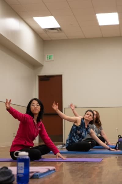 Plano City Council Member Lily Bao takes part in the free yoga class hosted at the Carpenter Park Recreation Center as part of the Rec Fest on Jan. 9. (Liesbeth Powers/Community Impact Newspaper)