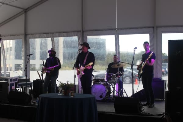 A photo of a band playing on a stage.