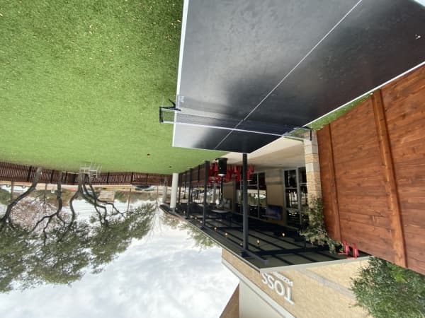 Toss' outdoor area features a ping pong table. 