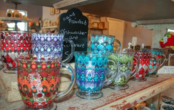 Hand-painted Stippled Glass coffee mugs are available at the boutique. (Hannah Zedaker/Community Impact Newspaper)