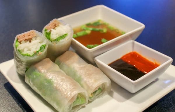 The Pho-Rollee ($5.95) consists of two beef meatball egg rolls served with hoisin sauce, Sriracha hot sauce and beef broth. (Adriana Rezal/Community Impact Newspaper) 