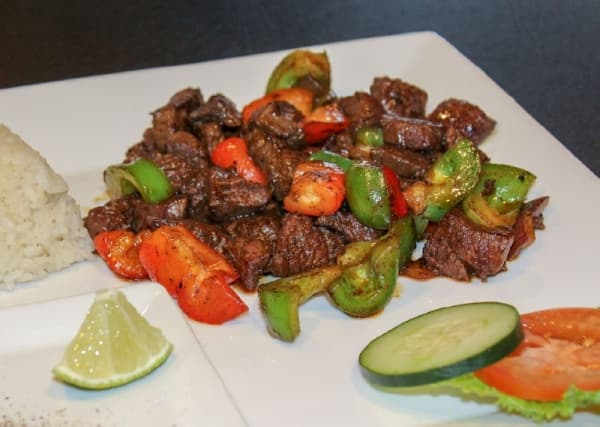 The Wok’n Beef ($17.95) consists of stir-fried, cubed filet mignon served with lime and steamed white rice. (Adriana Rezal/Community Impact Newspaper) 