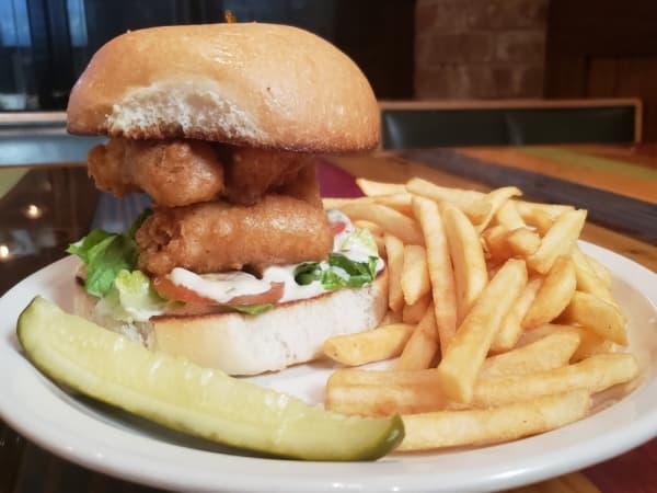 Fish sandwich with fried cod, tomato and tartar sauce on a bun ($9.99)